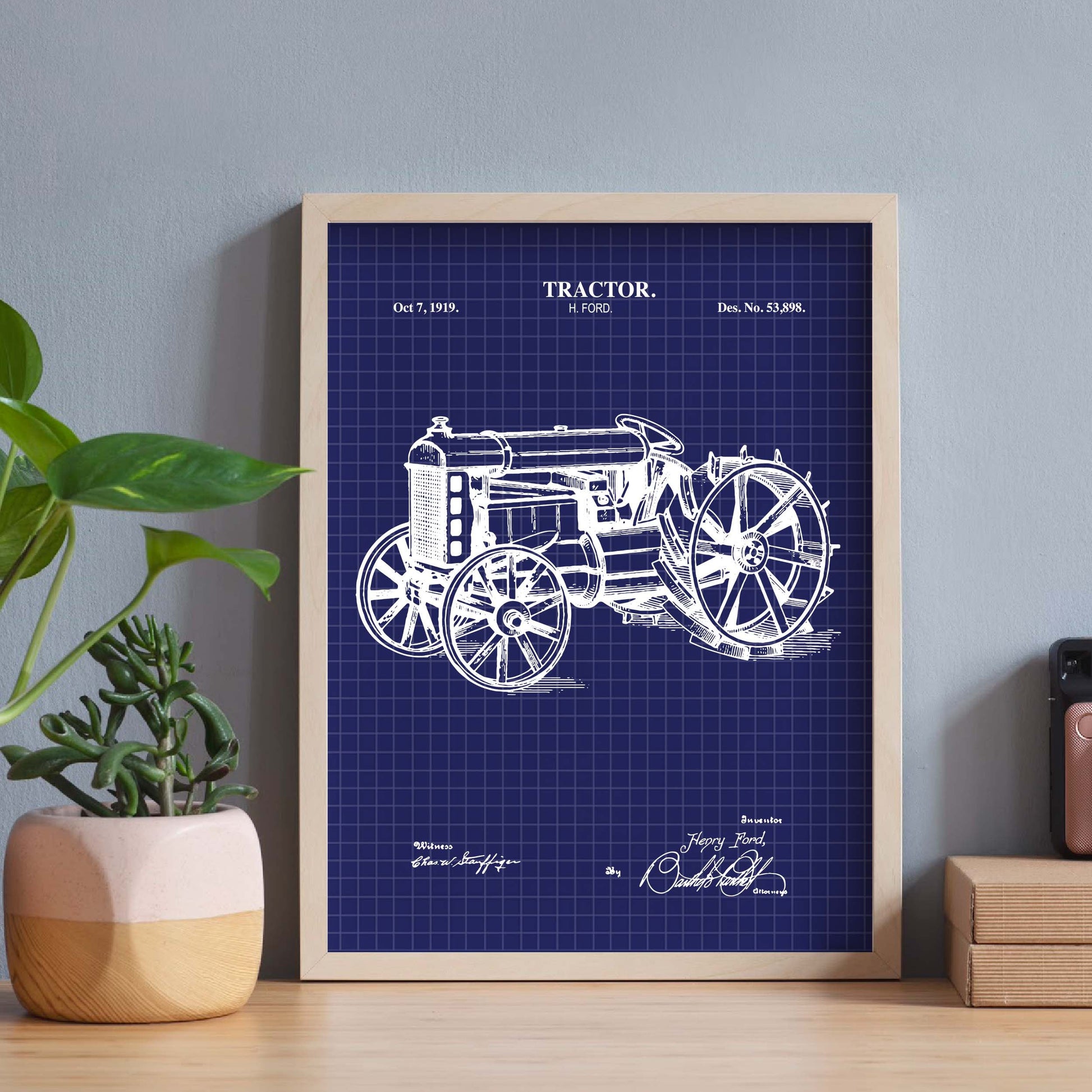 Antique tractor blueprint framed on a desk