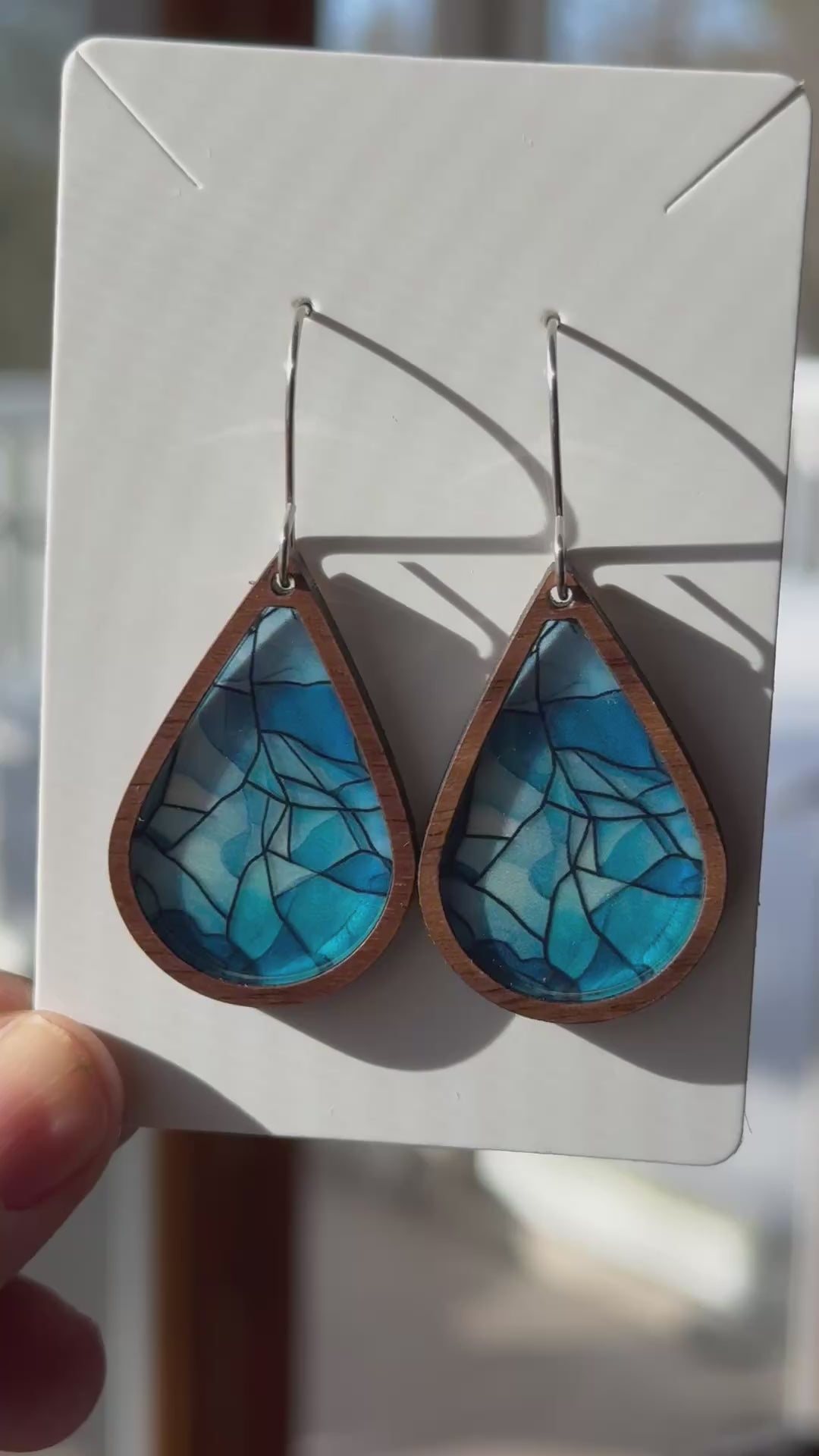 Video showing the faux stained glass earrings with light shining through them